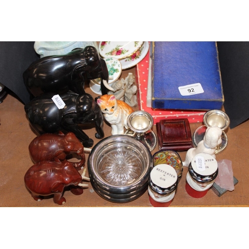 92 - Ebonised style elephants, cat models, hardwood stands, silver-plated candlesticks, flatware, coaster... 