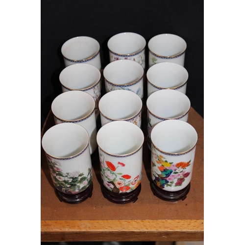 94 - Chinese Months of the Year porcelain vases on hardwood stands.