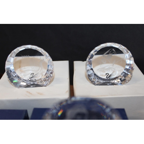 95 - Boxed Swarovski paperweights.