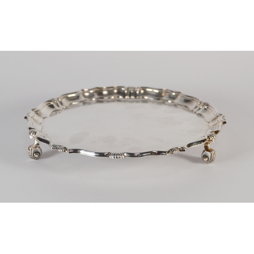44 - Edward VII silver card tray with scalloped and shell border, on scroll feet,by Hawksworth Eyre &... 
