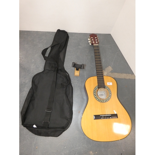 47 - Encore acoustic guitair, model ENC340FT, in carry case, and a guitar wall hook....