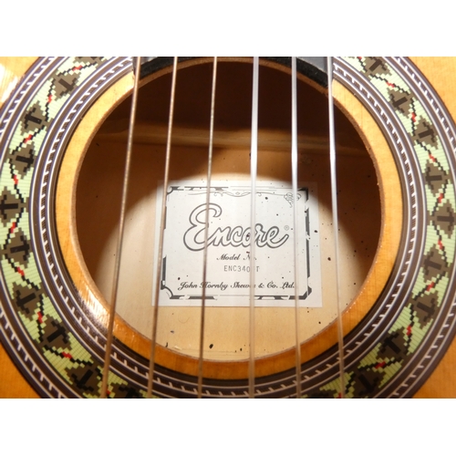 47 - Encore acoustic guitair, model ENC340FT, in carry case, and a guitar wall hook....