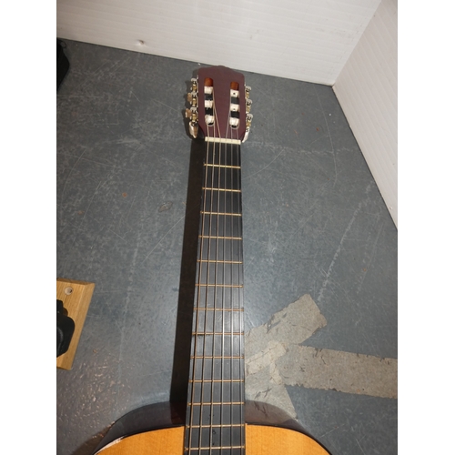 47 - Encore acoustic guitair, model ENC340FT, in carry case, and a guitar wall hook....