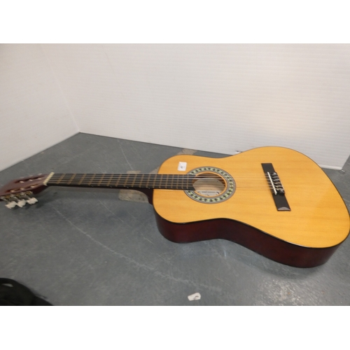 47 - Encore acoustic guitair, model ENC340FT, in carry case, and a guitar wall hook....