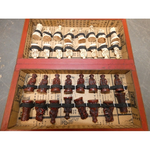 76 - Modern boxed Chinese export chess pieces in red and white resin, depicting various immortals and oth... 