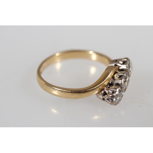 176 - 18ct yellow gold diamond three stone crossover ring, the diamonds and claw setting, size K, 3.4g.