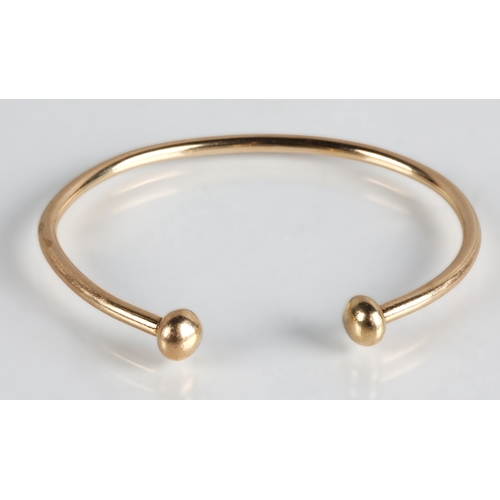 110 - Yellow metal bangle tested as 9ct gold, 17.3g