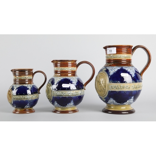 13 - Graduated set of three Doulton Lambeth stoneware jugs depicting Queen Victoria, largest measures 23c... 