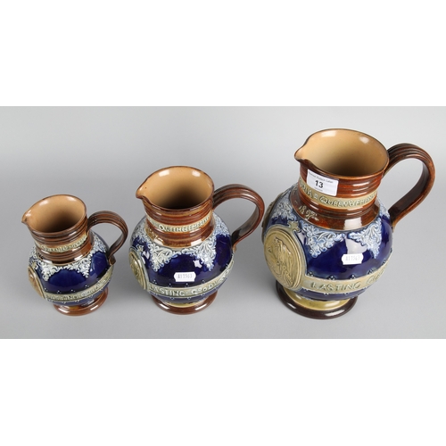 13 - Graduated set of three Doulton Lambeth stoneware jugs depicting Queen Victoria, largest measures 23c... 