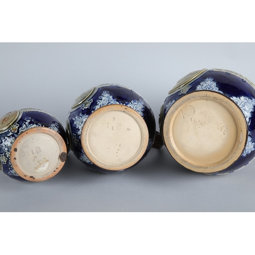 13 - Graduated set of three Doulton Lambeth stoneware jugs depicting Queen Victoria, largest measures 23c... 
