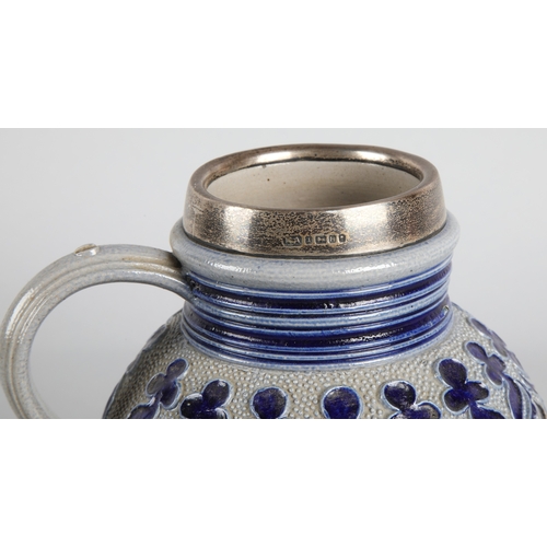 35 - German style salt-glazed silver mounted jug, 18cm h.
