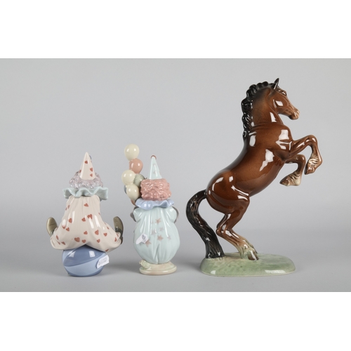 38 - Two Lladro figures to include Littlest Clown' 5811 and 'Having a Ball' 5813, with Beswick 'Rearing W... 