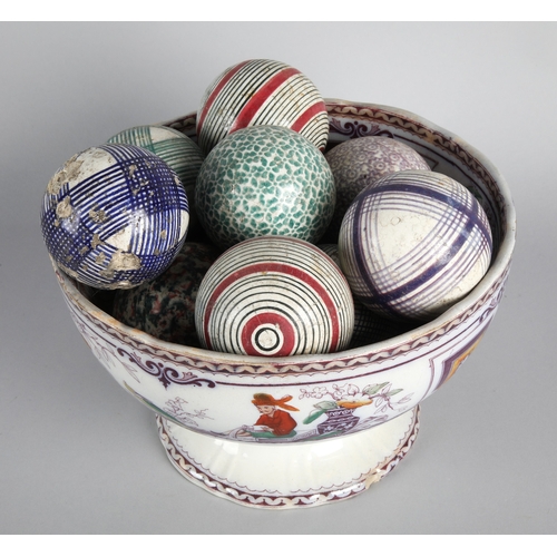 46 - Collection of Victorian carpet bowls in a pedestal bowl.