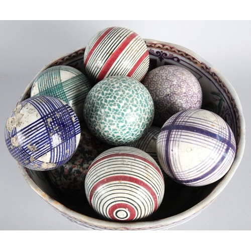 46 - Collection of Victorian carpet bowls in a pedestal bowl.