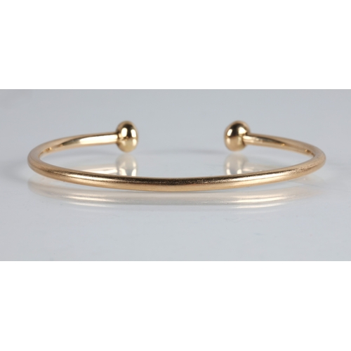 110 - Yellow metal bangle tested as 9ct gold, 17.3g