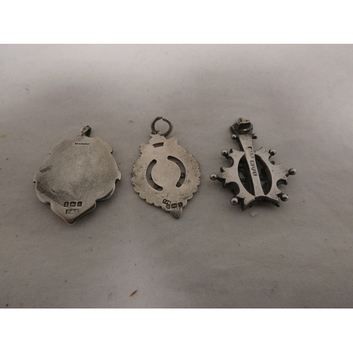 178 - Silver overlaid pendant and two silver medal fobs, 178g gross.  (3)