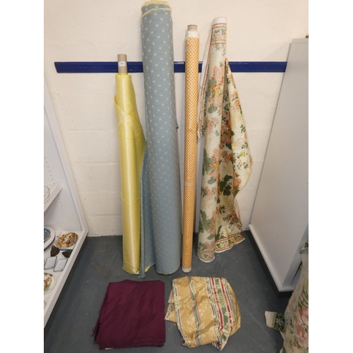 101 - Four rolls of fabric and cuts.