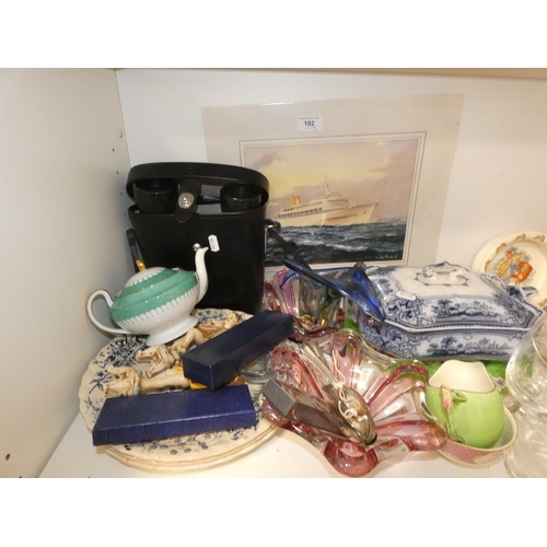 102 - Shelf lot of sundries to include pair of binoculars in case, P&O liner print, glass, ceramics an... 