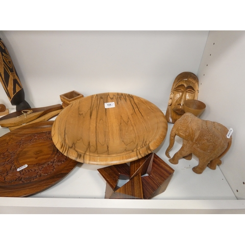 108 - Two shelves of treen and wood items to include bowls, figures, letter rack and ornaments.&nbsp;