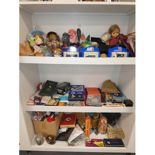 110 - Three shelves of sundries to include boxed model vehicles, games, reels of thread and ornaments, sof... 