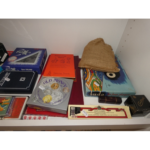 110 - Three shelves of sundries to include boxed model vehicles, games, reels of thread and ornaments, sof... 