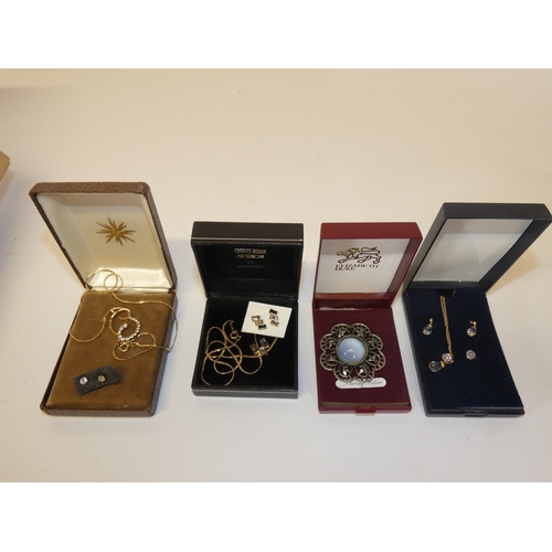 153 - Box of costume jewellery to include boxed brooches, pendants on chains, and pairs of earrings.&nbsp;