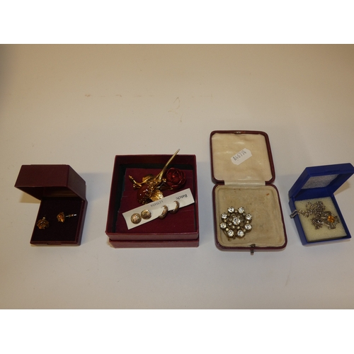 153 - Box of costume jewellery to include boxed brooches, pendants on chains, and pairs of earrings.&nbsp;