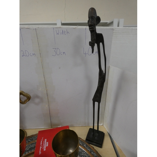 75 - Two Middle Eastern style copper trays, brass ornaments and cast bronze African tribal figure.&nbsp;