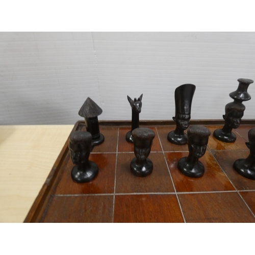 77 - Chess board with African tribal themed pieces, tray and boomerang etc.