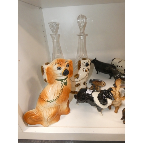 93 - Shelf lot of ceramics to include wally dugs, Beswick cows (damaged) Wade tortoise and similar, group... 