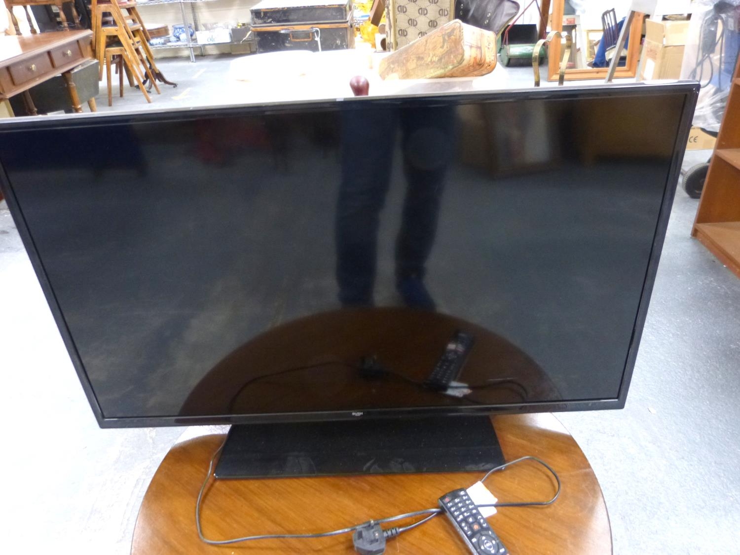 Bush flat screen TV and remote.