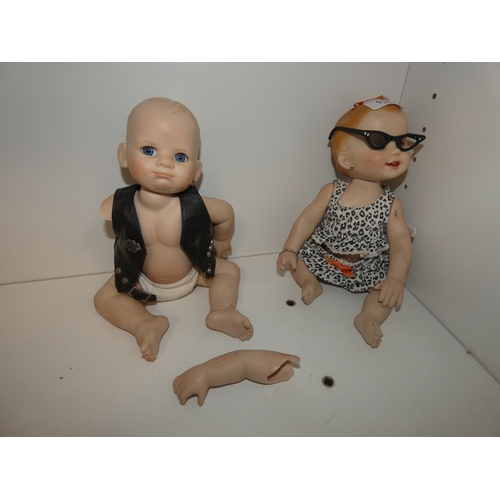 113 - Two china dolls in the form of a boy and girl, with clothing.&nbsp; (2)