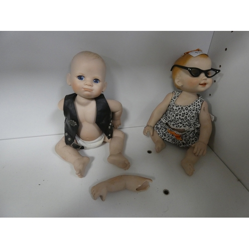 113 - Two china dolls in the form of a boy and girl, with clothing.&nbsp; (2)