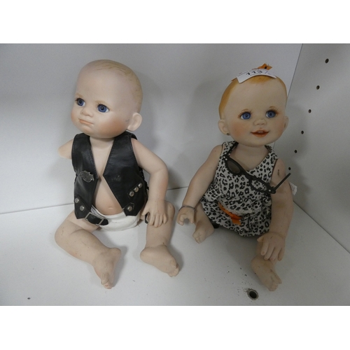 113 - Two china dolls in the form of a boy and girl, with clothing.&nbsp; (2)