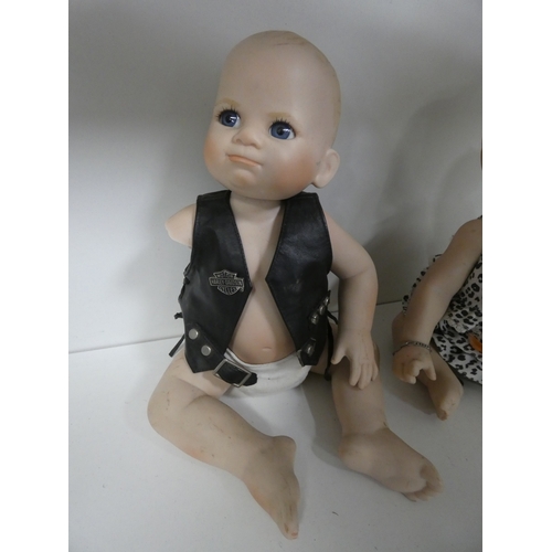 113 - Two china dolls in the form of a boy and girl, with clothing.&nbsp; (2)