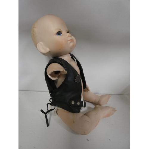 113 - Two china dolls in the form of a boy and girl, with clothing.&nbsp; (2)