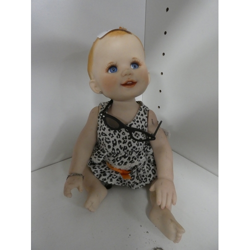 113 - Two china dolls in the form of a boy and girl, with clothing.&nbsp; (2)