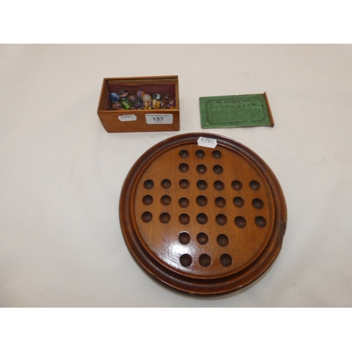 157 - Collection of antique marbles in a box, 'The Improved Game', and a related mahogany solitaire board.