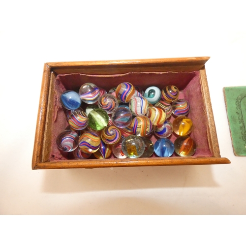 157 - Collection of antique marbles in a box, 'The Improved Game', and a related mahogany solitaire board.