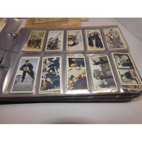 159 - Folder containing cigarette cards to include railways, military, flags, maritime, world landmarks, M... 