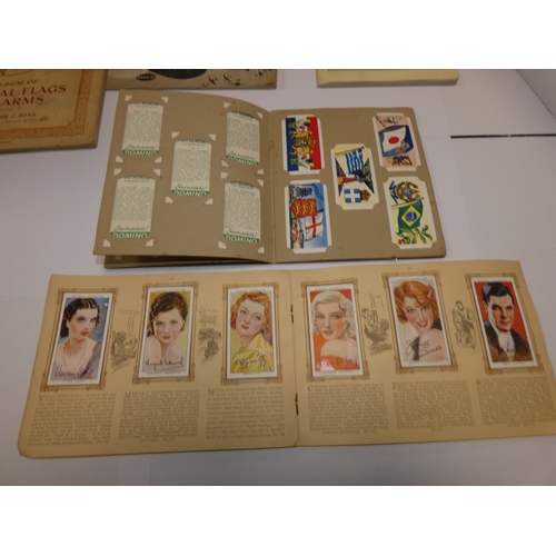 159 - Folder containing cigarette cards to include railways, military, flags, maritime, world landmarks, M... 