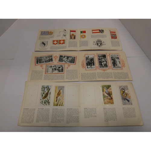 159 - Folder containing cigarette cards to include railways, military, flags, maritime, world landmarks, M... 