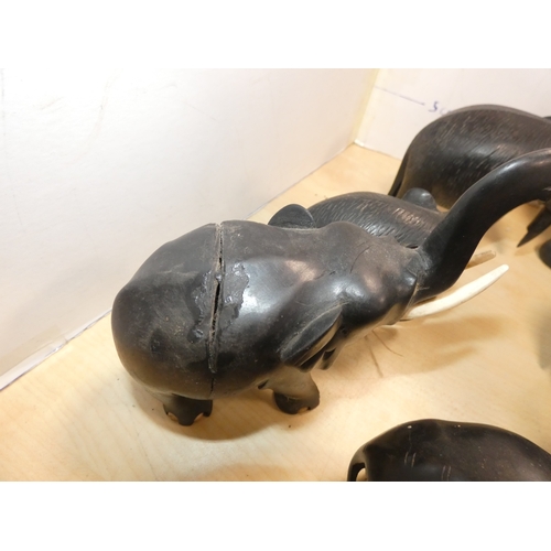 20 - Group of ebonised elephant figures, some with original bone tusks.