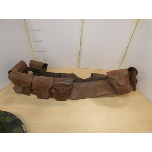 28 - WWII style military helmet, and ammunition belt. (2)