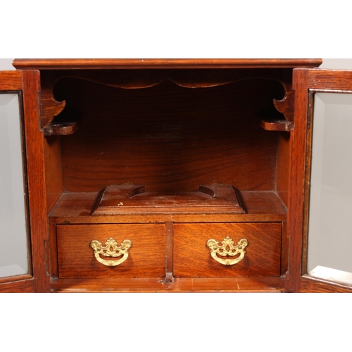 22 - Oak cased two door smokers cabinet, 33cm tall.&nbsp;