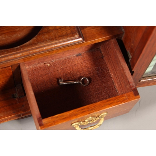 22 - Oak cased two door smokers cabinet, 33cm tall.&nbsp;