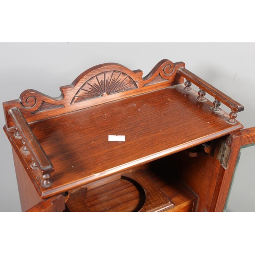 22 - Oak cased two door smokers cabinet, 33cm tall.&nbsp;