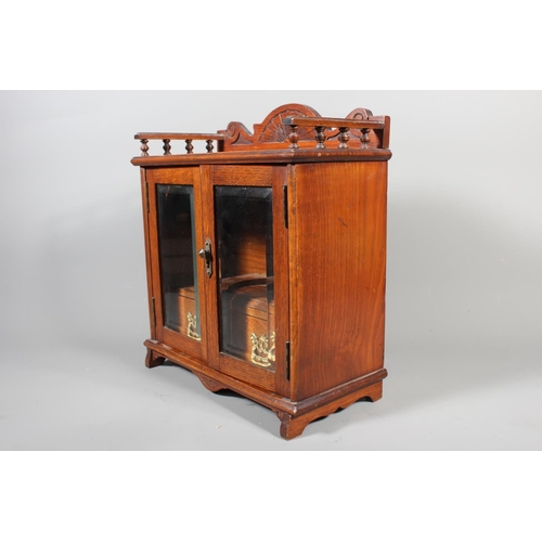 22 - Oak cased two door smokers cabinet, 33cm tall.&nbsp;