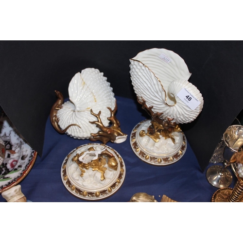 48 - Two Royal Worcester nautilus shell vases, one broken and restored, 22cm tall. (2)