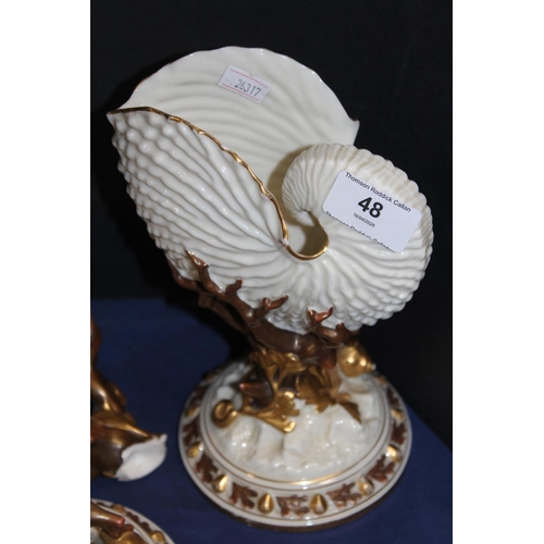48 - Two Royal Worcester nautilus shell vases, one broken and restored, 22cm tall. (2)